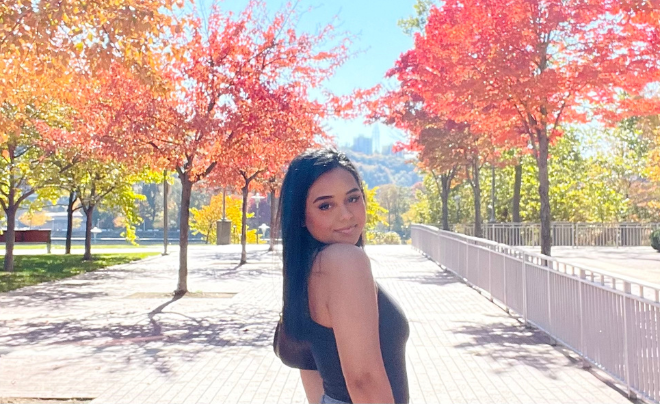 Brittnay Hernandez in front of fall foliage