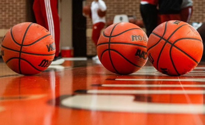 Three basketballs on a basketball court