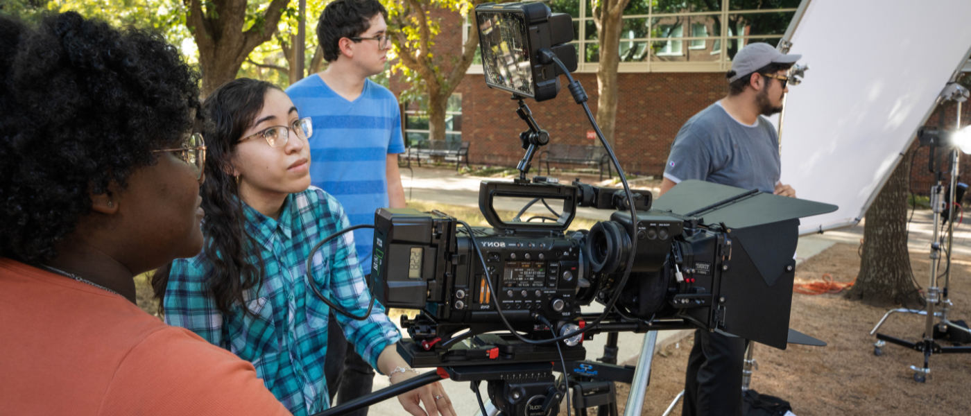 Students filming with a camera