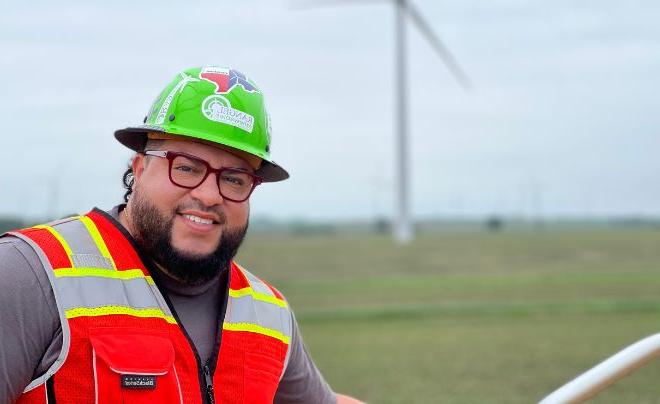 Josh Rangel in front of a windmill