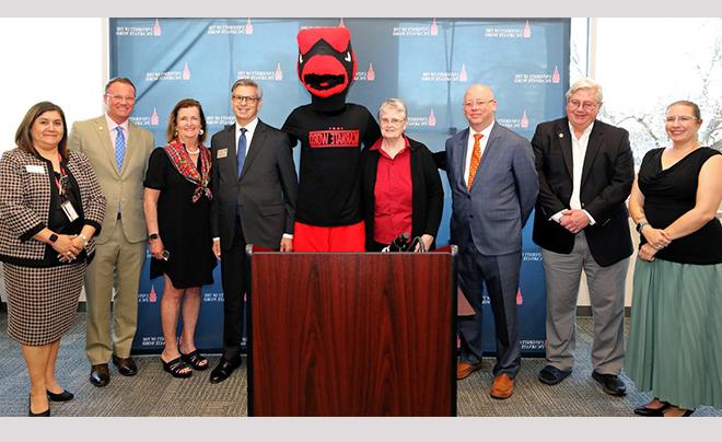 Red posing with UIW representatives