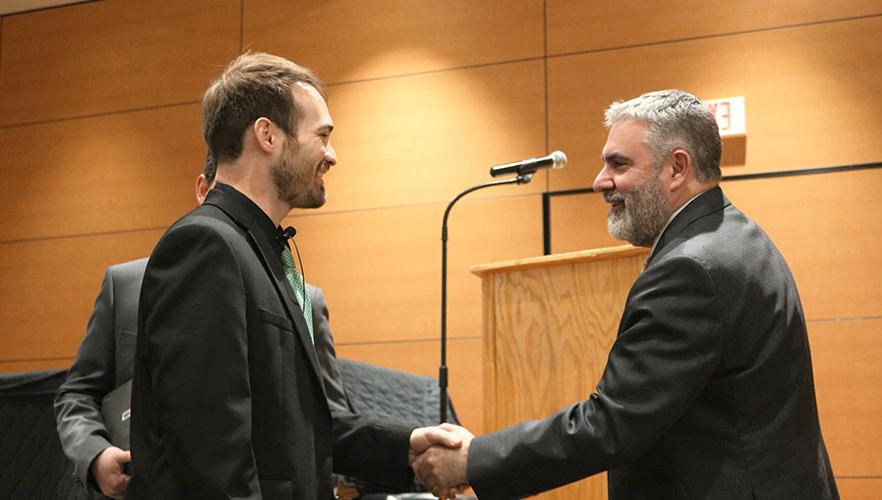 Rerick shaking hands with Dr. Clavere