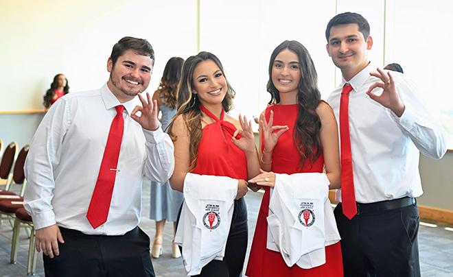 four students at whit coat ceremony